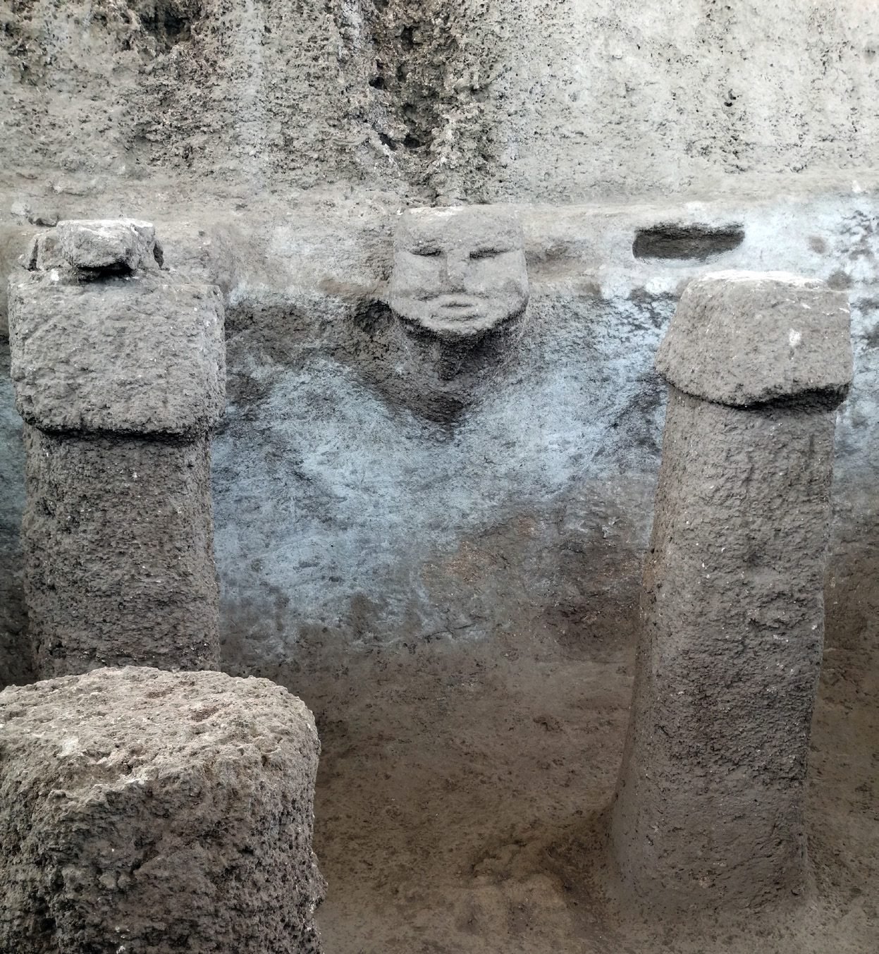 A human head carved from the bedrock between two phallic pillars in Structure AB at Karahan Tepe