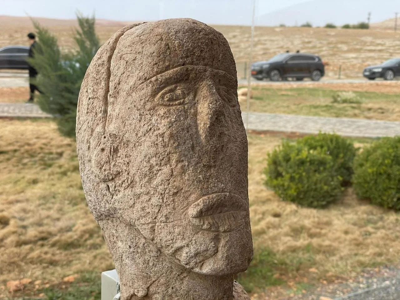 The 2025 Sayburç stitched-mouth statue — carved eyes and a sewn-shut mouth